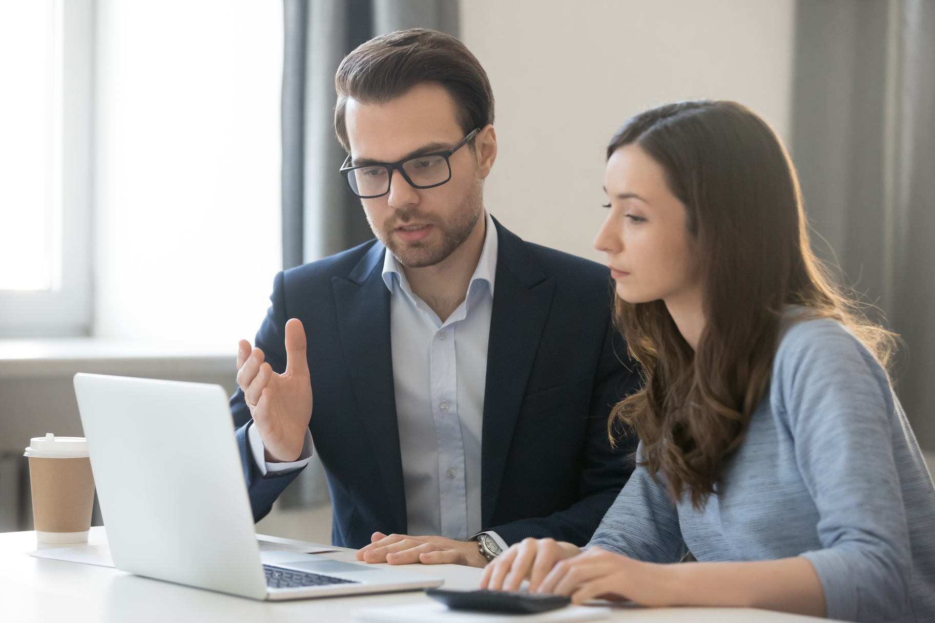 Helpful boss mentor explaining new online project to worker intern